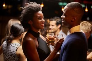 Couples Dancing And Drinking At Evening Party