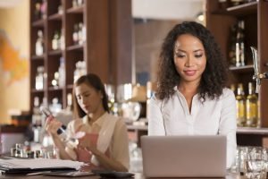 Female bar owner and waitress getting ready for opening