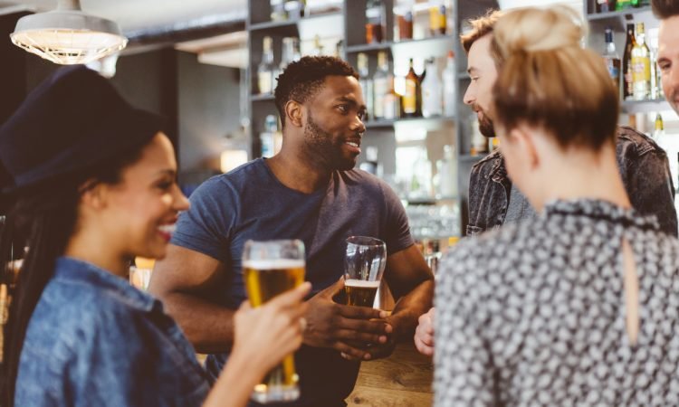 Friends meeting in a pub drinking beer