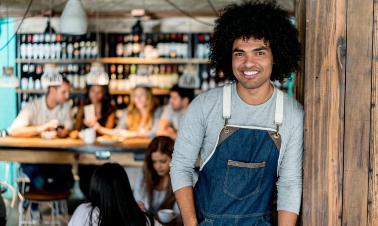 Happy African American waiter